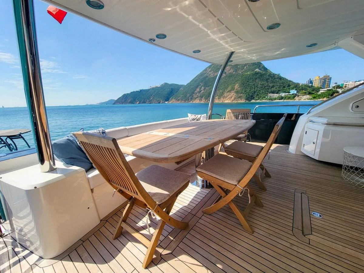 a deck with chairs and a table on it aboard 2008 SUNSEEKER 90  @ ACAPULCO Yacht for Sale