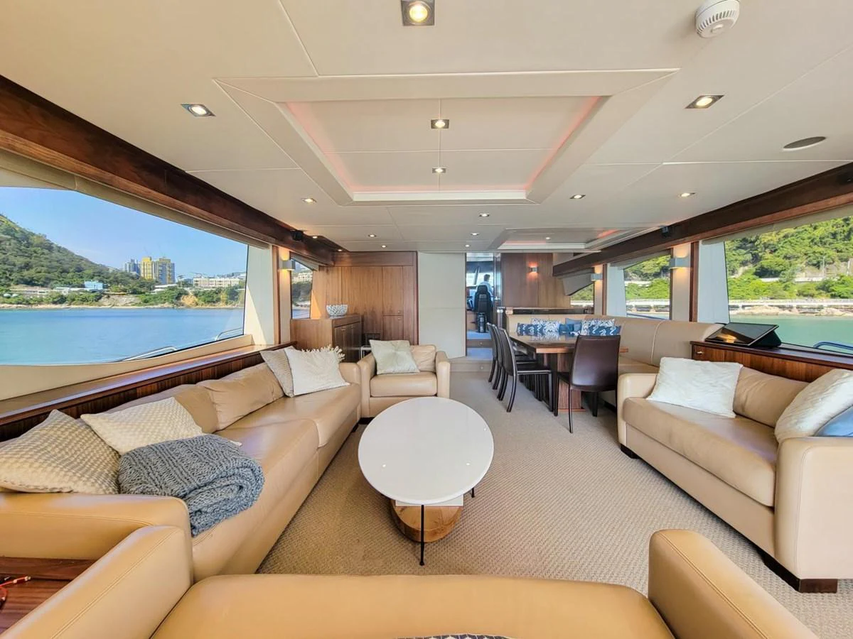 a living room with a large window aboard 2008 SUNSEEKER 90  @ ACAPULCO Yacht for Sale
