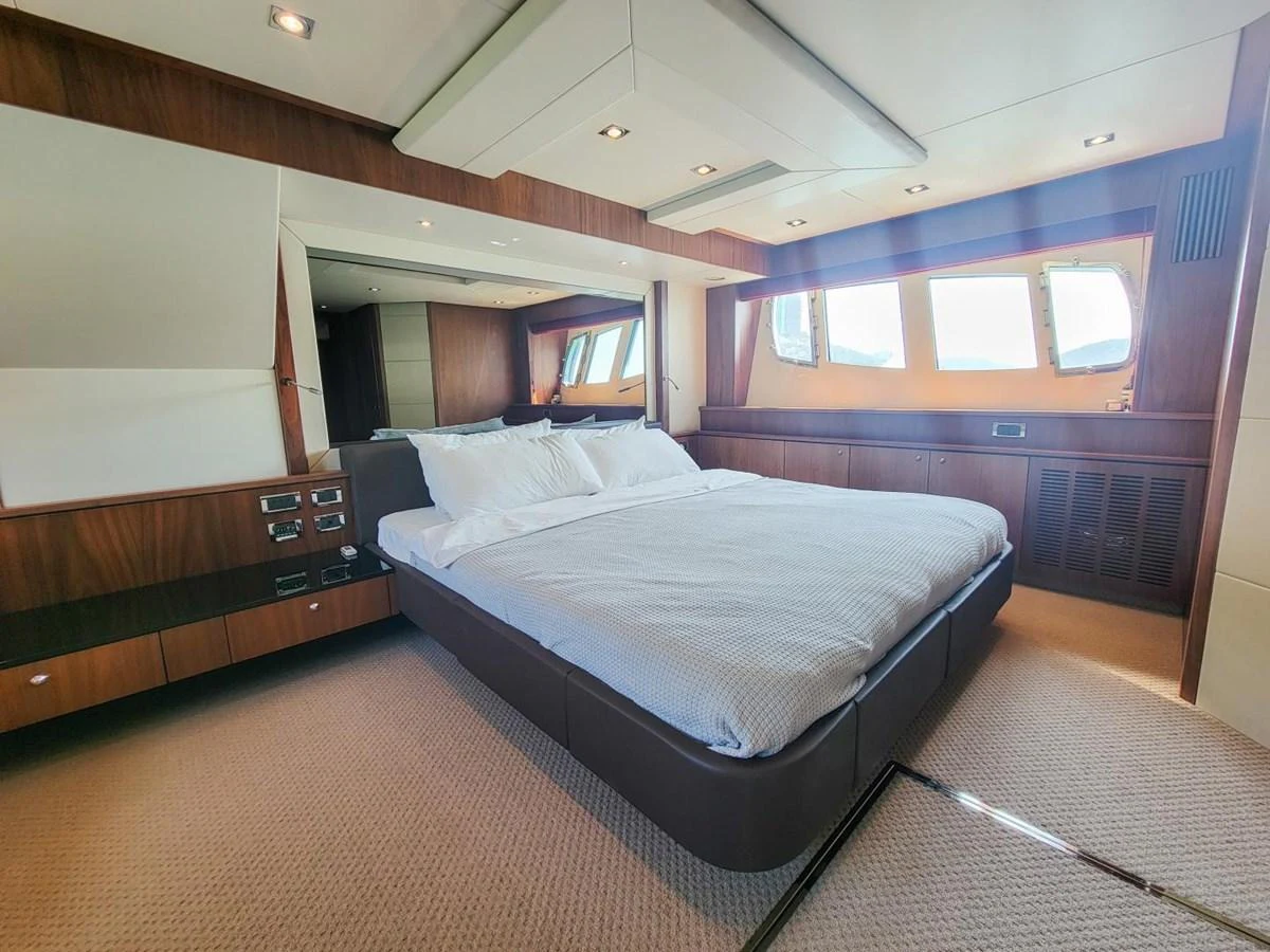a room with a bed and a window aboard 2008 SUNSEEKER 90  @ ACAPULCO Yacht for Sale