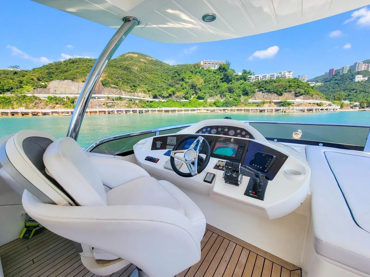 a white lounge chair on a deck overlooking a body of water aboard 2008 SUNSEEKER 90  @ ACAPULCO Yacht for Sale