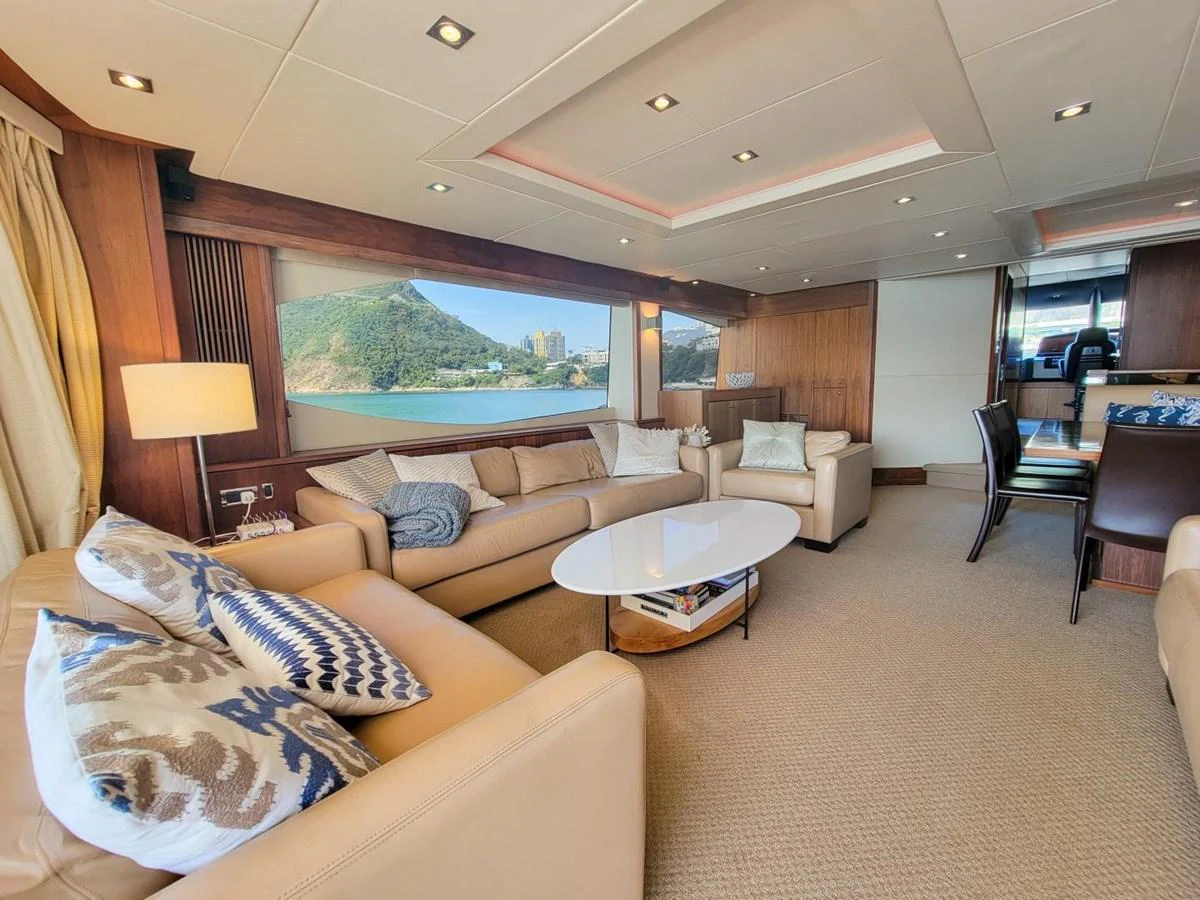 a living room with a large screen aboard 2008 SUNSEEKER 90  @ ACAPULCO Yacht for Sale