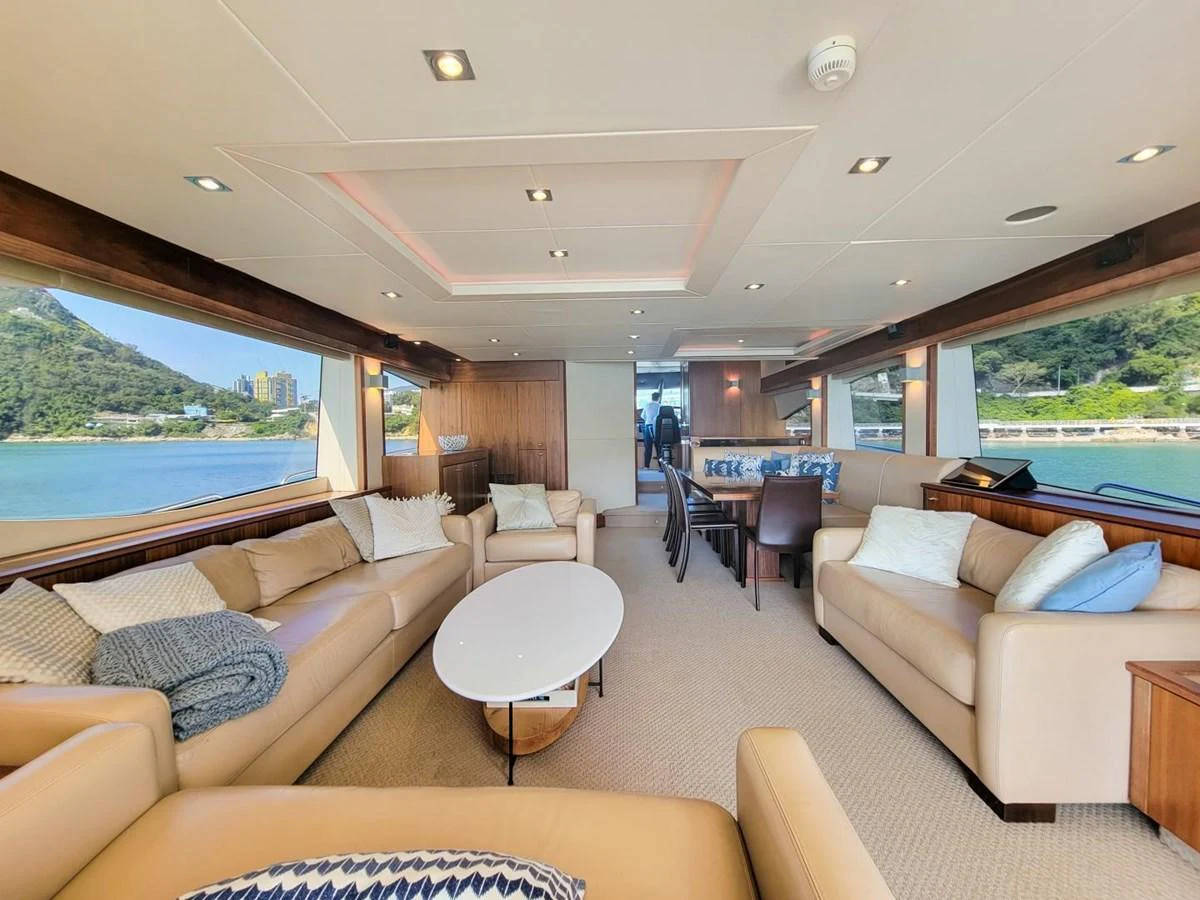 a living room with a large window aboard 2008 SUNSEEKER 90  @ ACAPULCO Yacht for Sale