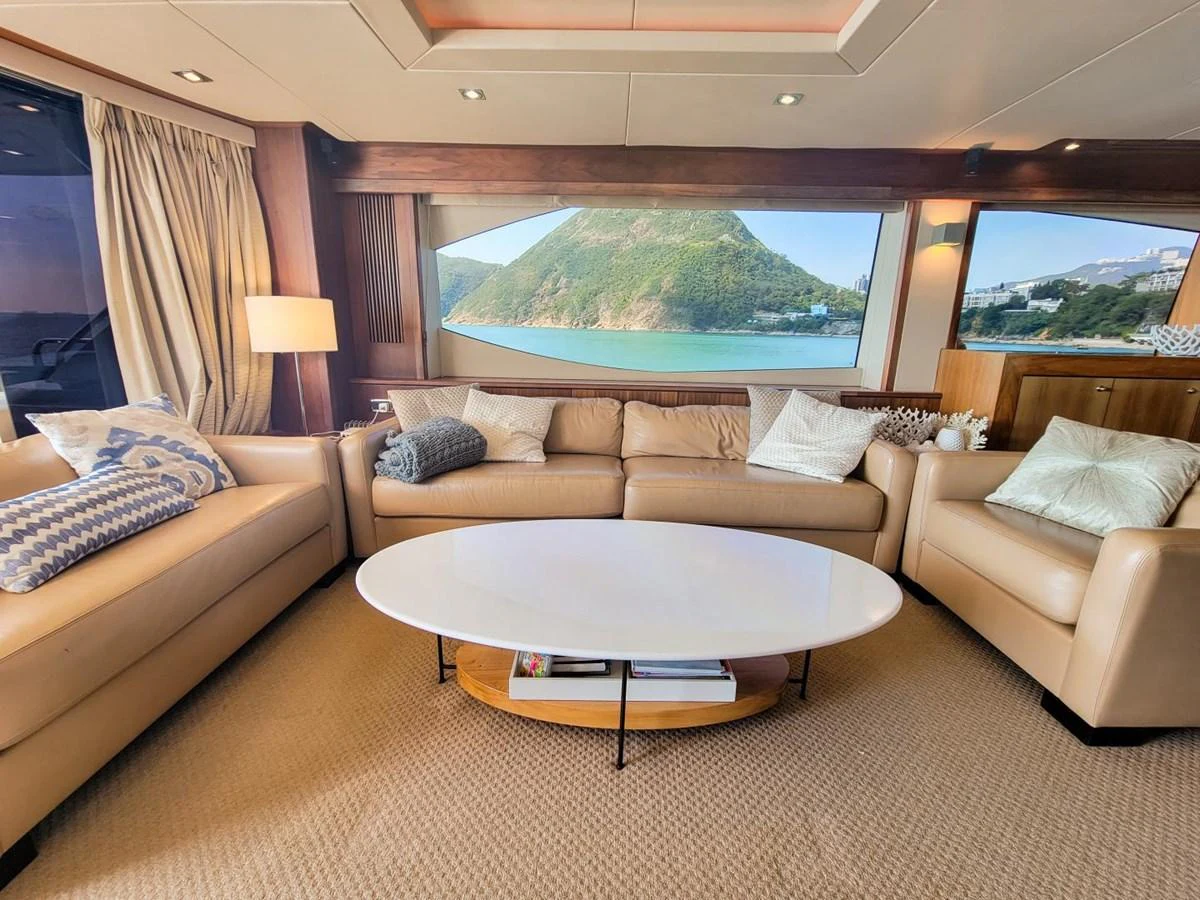 a living room with a large sofa and a large television aboard 2008 SUNSEEKER 90  @ ACAPULCO Yacht for Sale