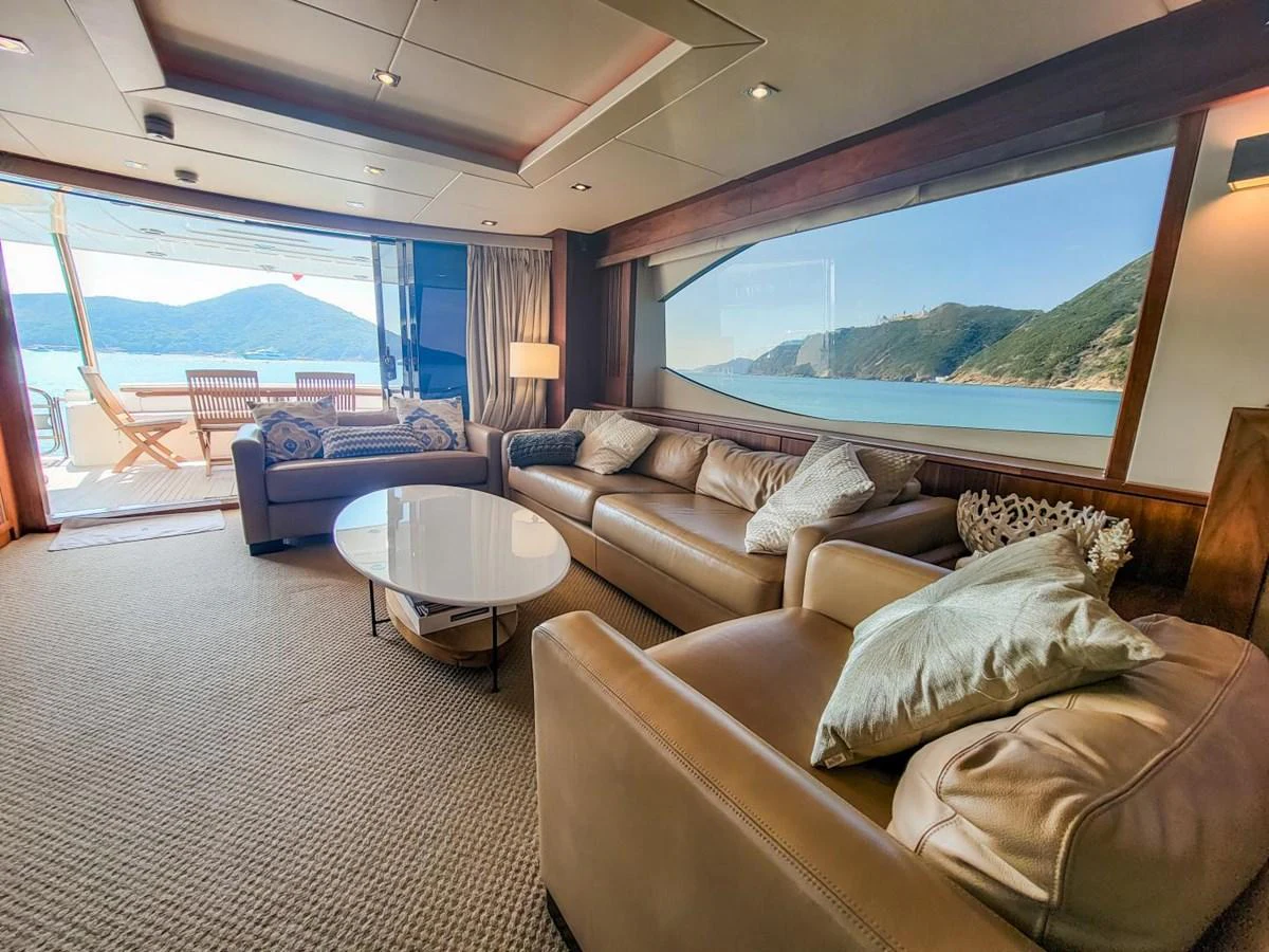 a living room with a large window aboard 2008 SUNSEEKER 90  @ ACAPULCO Yacht for Sale