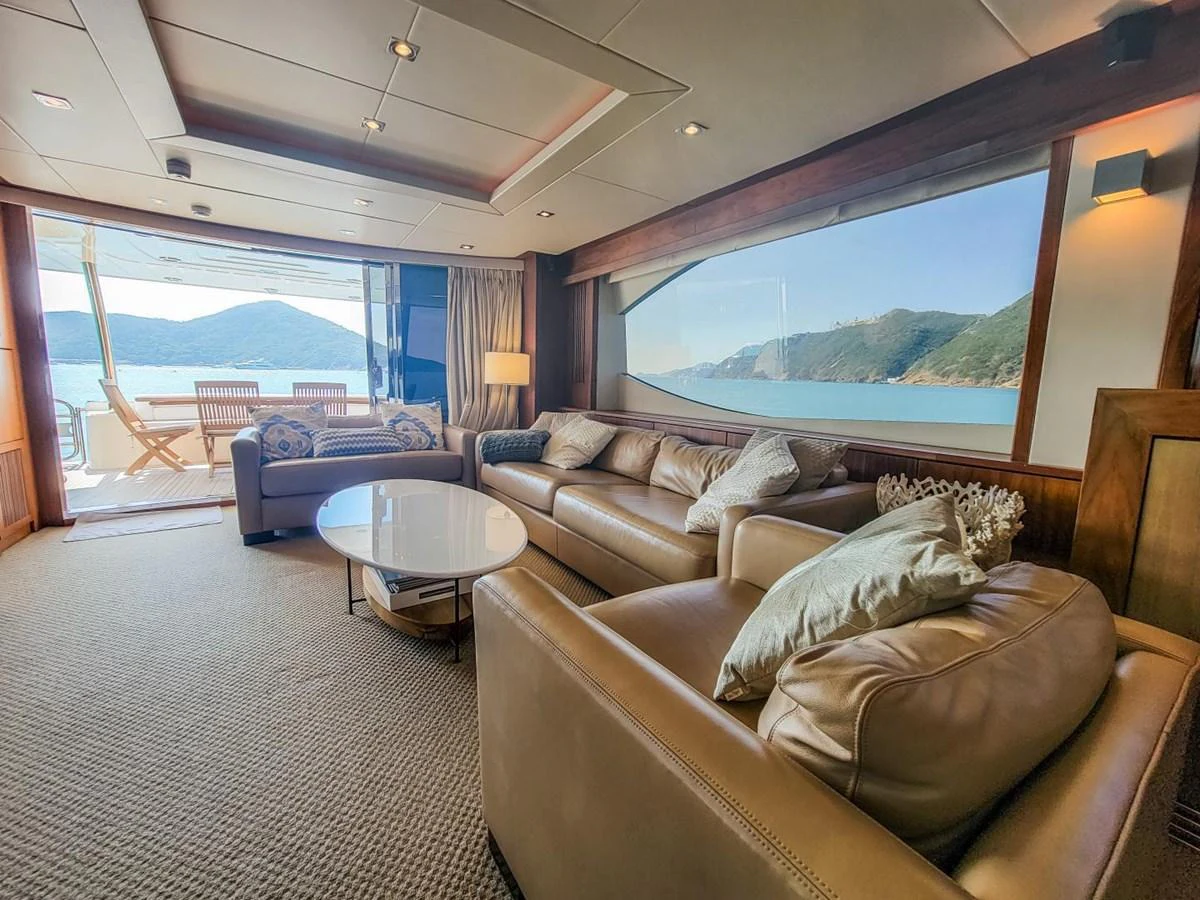 a living room with a large window aboard 2008 SUNSEEKER 90  @ ACAPULCO Yacht for Sale
