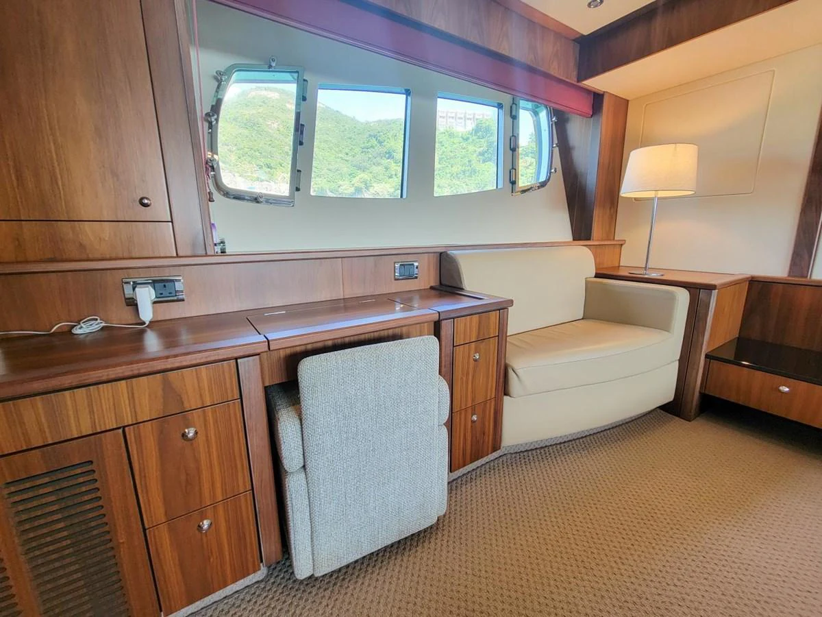 a living room with a couch and a desk aboard 2008 SUNSEEKER 90  @ ACAPULCO Yacht for Sale