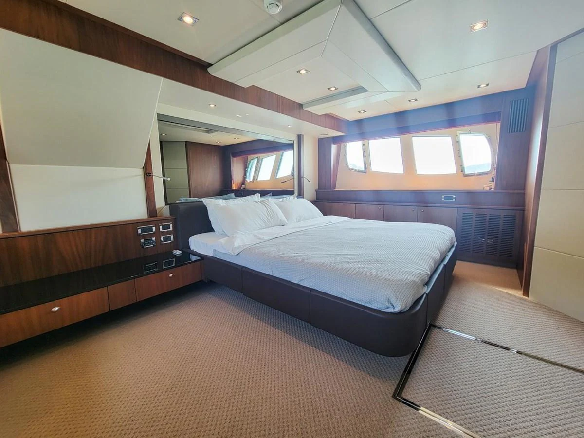 a room with a bed and a desk aboard 2008 SUNSEEKER 90  @ ACAPULCO Yacht for Sale