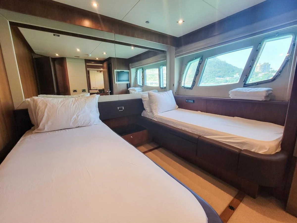 a room with beds and a window aboard 2008 SUNSEEKER 90  @ ACAPULCO Yacht for Sale