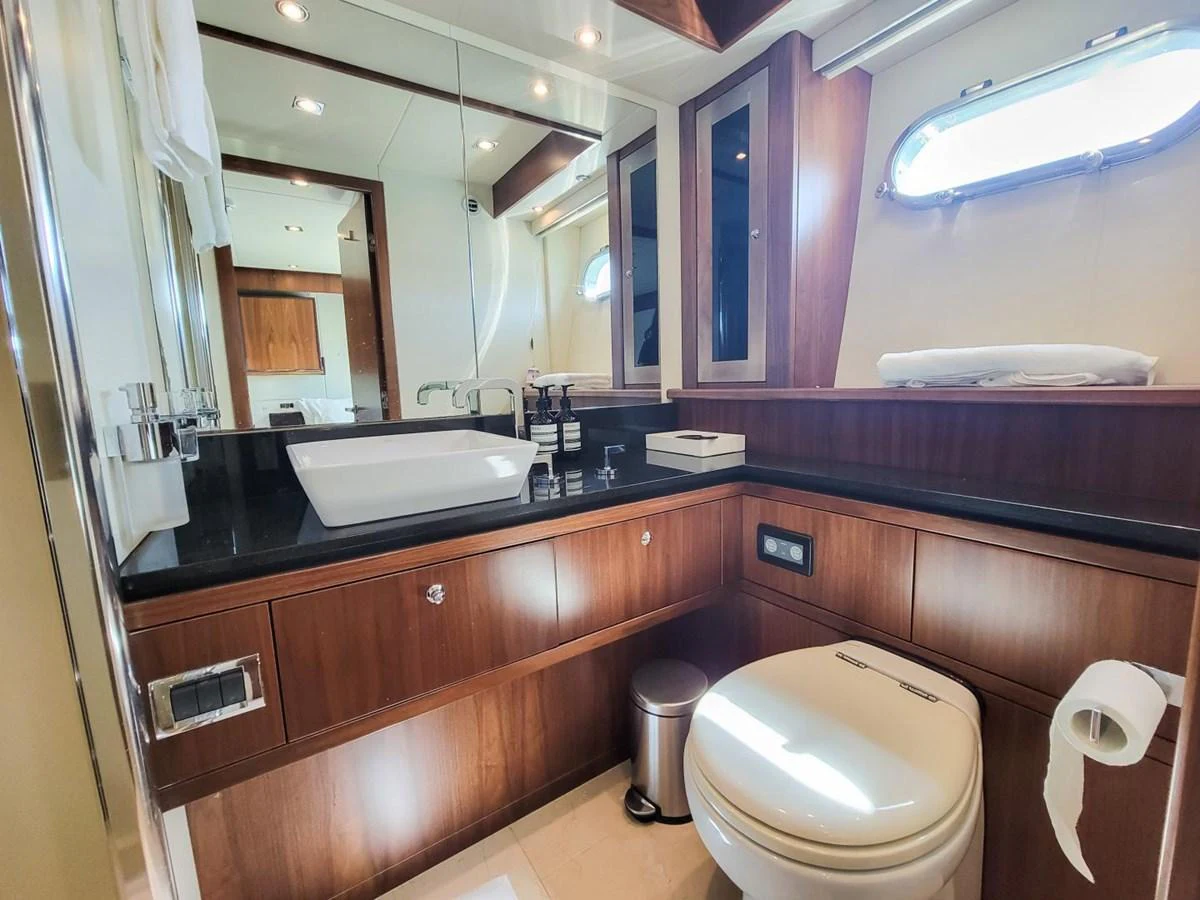 a bathroom with a sink toilet and a mirror aboard 2008 SUNSEEKER 90  @ ACAPULCO Yacht for Sale