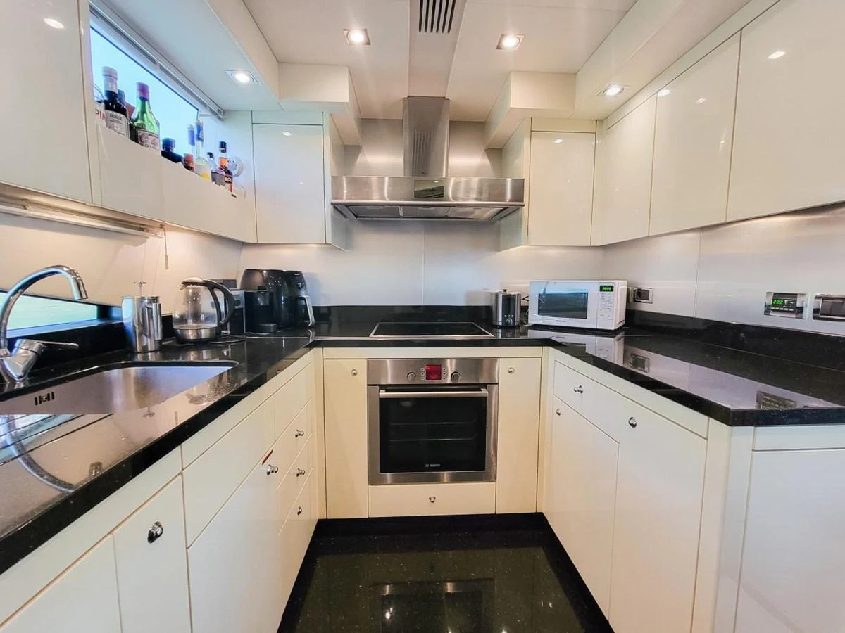 a kitchen with white cabinets aboard 2008 SUNSEEKER 90  @ ACAPULCO Yacht for Sale