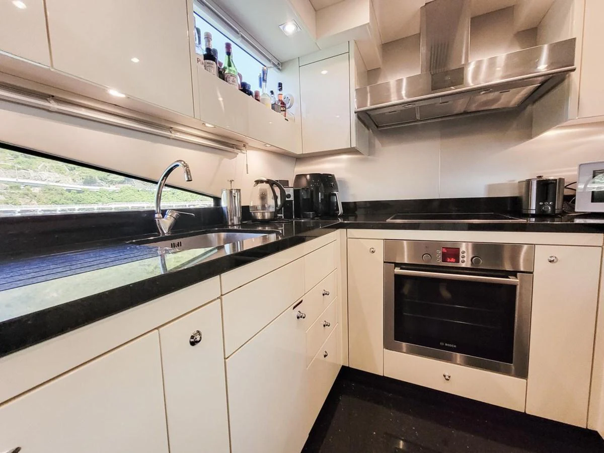 a kitchen with white cabinets aboard 2008 SUNSEEKER 90  @ ACAPULCO Yacht for Sale