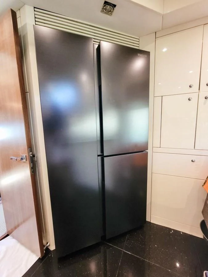 a stainless steel refrigerator in a kitchen aboard 2008 SUNSEEKER 90  @ ACAPULCO Yacht for Sale