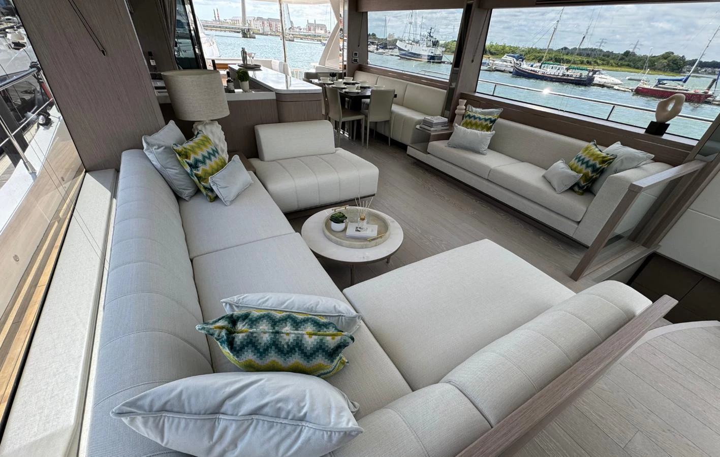 The yacht's salon features elegant seating with a view of the marina. aboard SVETLANA Yacht for Sale