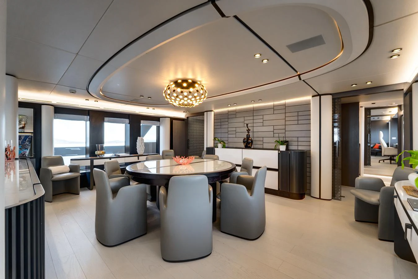 The yacht's dining area features a modern, elegant design with plush seating and sophisticated lighting. aboard L.A.U.L. Yacht for Sale