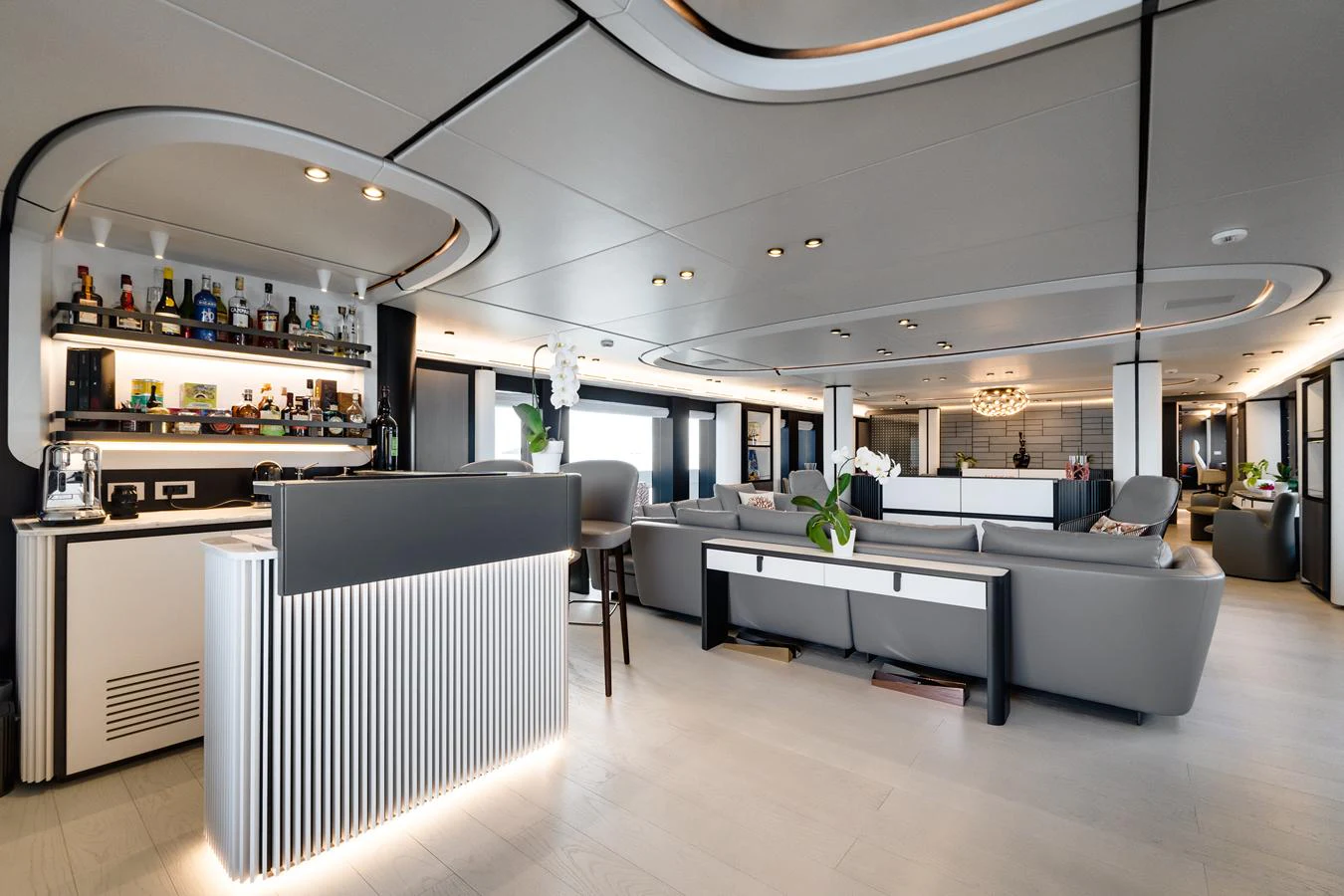 The spacious salon features modern furnishings and a well-stocked bar, creating an inviting atmosphere for relaxation and socializing. aboard L.A.U.L. Yacht for Sale