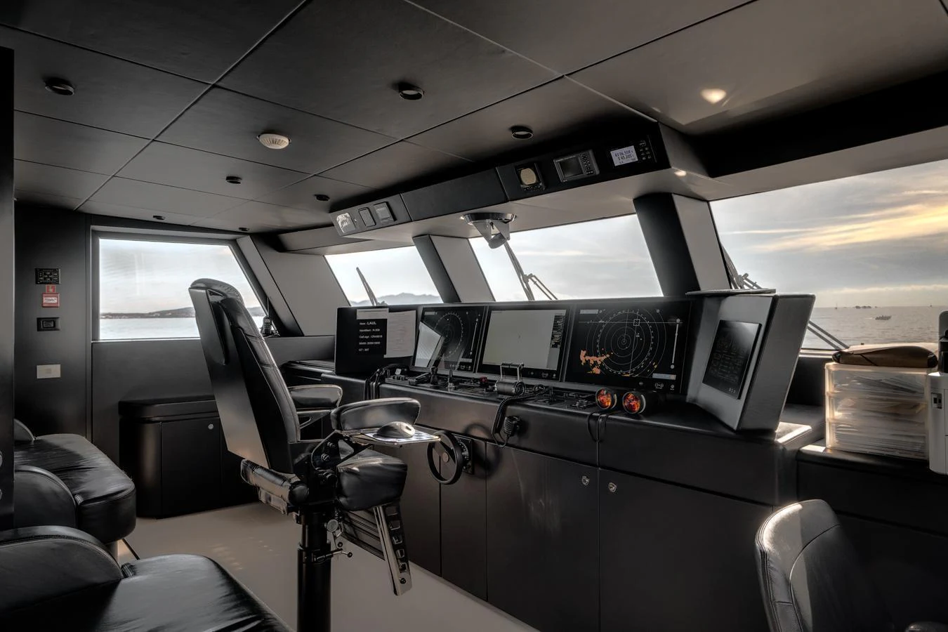 The helm station features advanced navigation equipment and a sleek, modern design. aboard L.A.U.L. Yacht for Sale