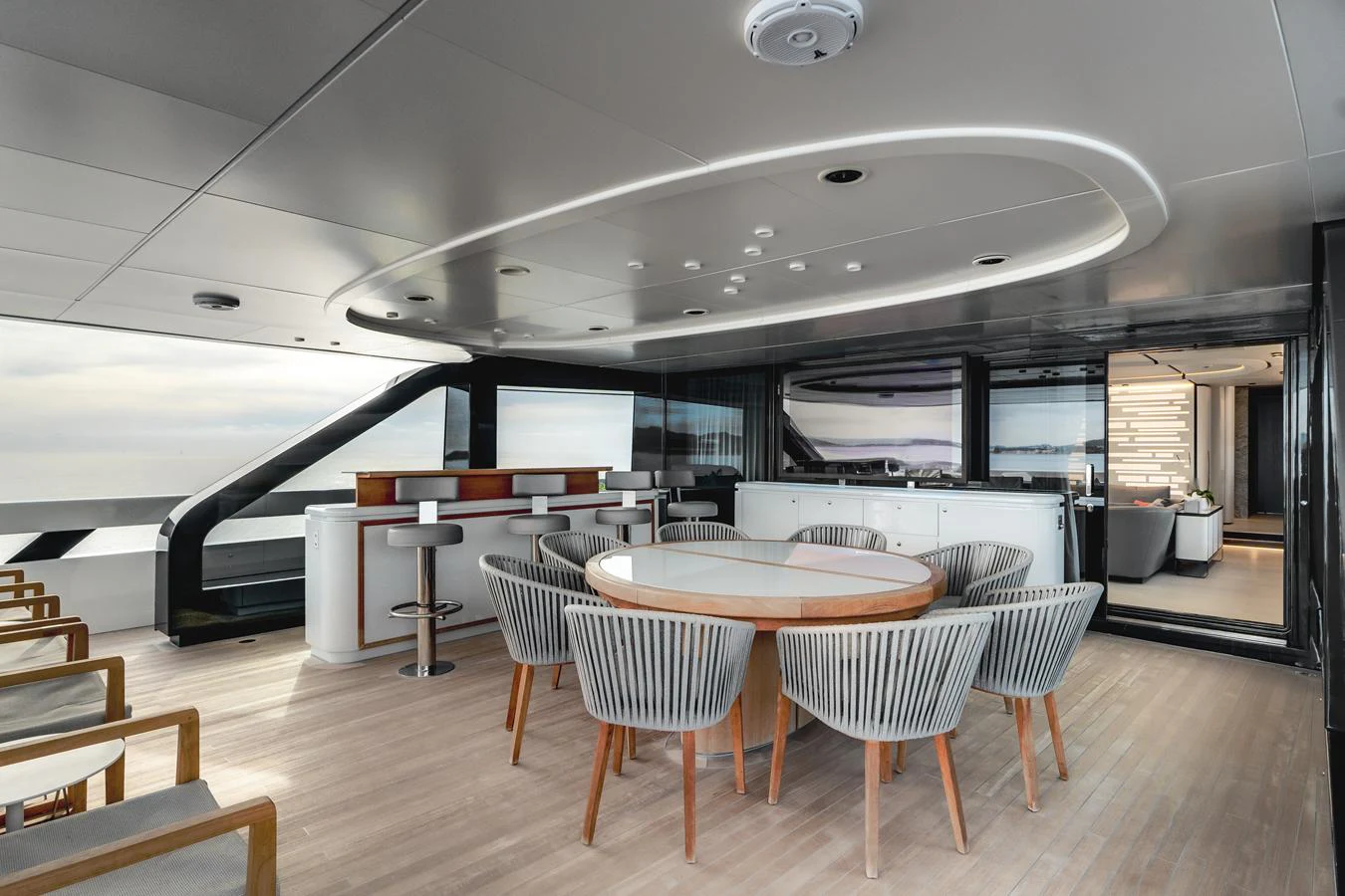 The aft deck features a stylish dining area with modern furnishings and panoramic views. aboard L.A.U.L. Yacht for Sale