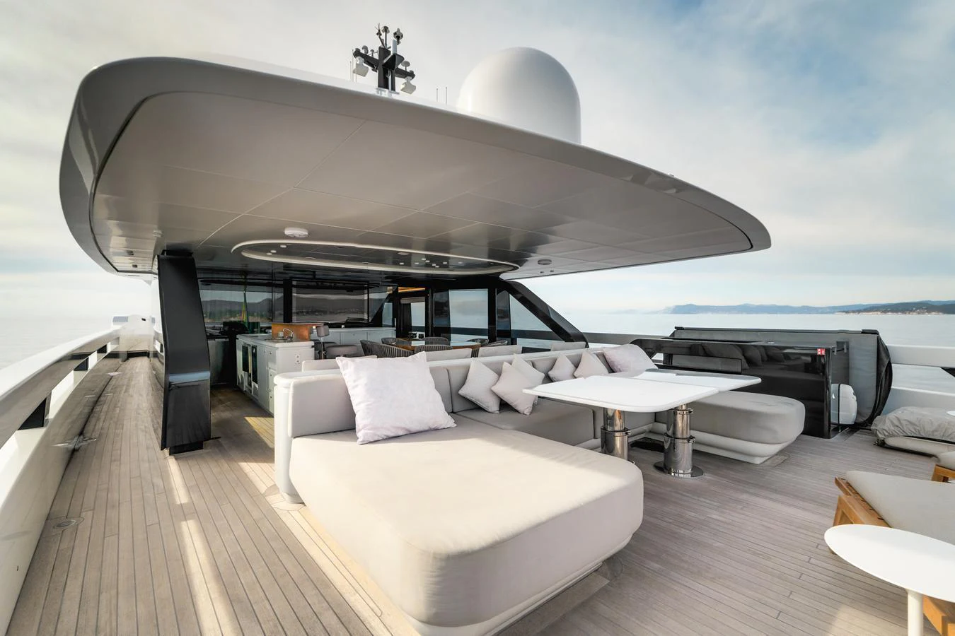 The flybridge offers a spacious and luxurious outdoor lounging area with modern furnishings and panoramic views. aboard L.A.U.L. Yacht for Sale