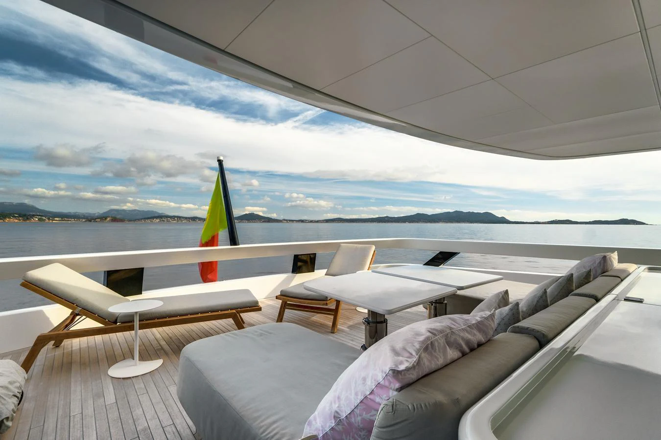 The aft deck offers a serene lounging area with comfortable seating and stunning views of the water. aboard L.A.U.L. Yacht for Sale