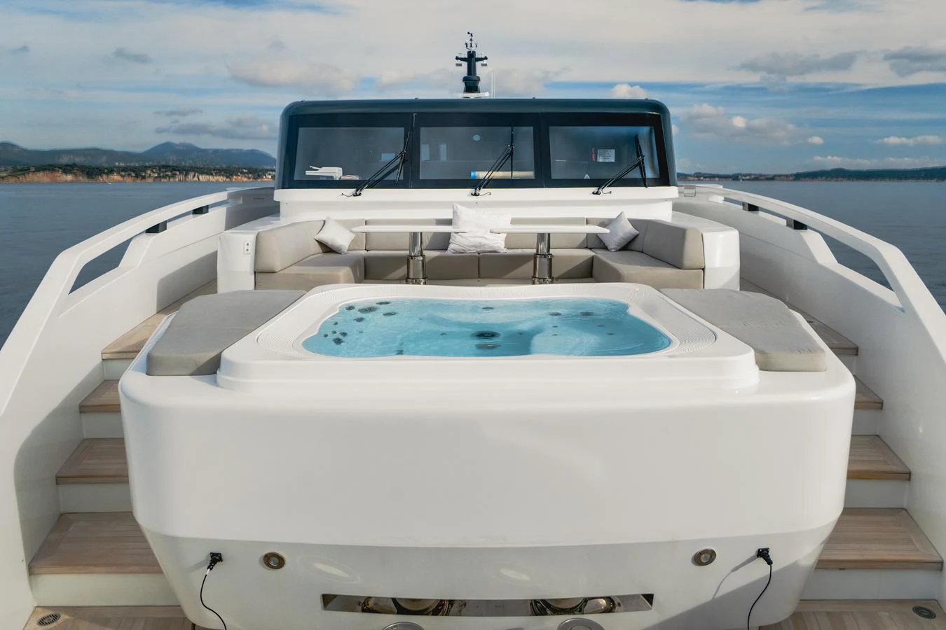 The yacht features a luxurious sundeck with a spacious hot tub and comfortable seating area. aboard L.A.U.L. Yacht for Sale