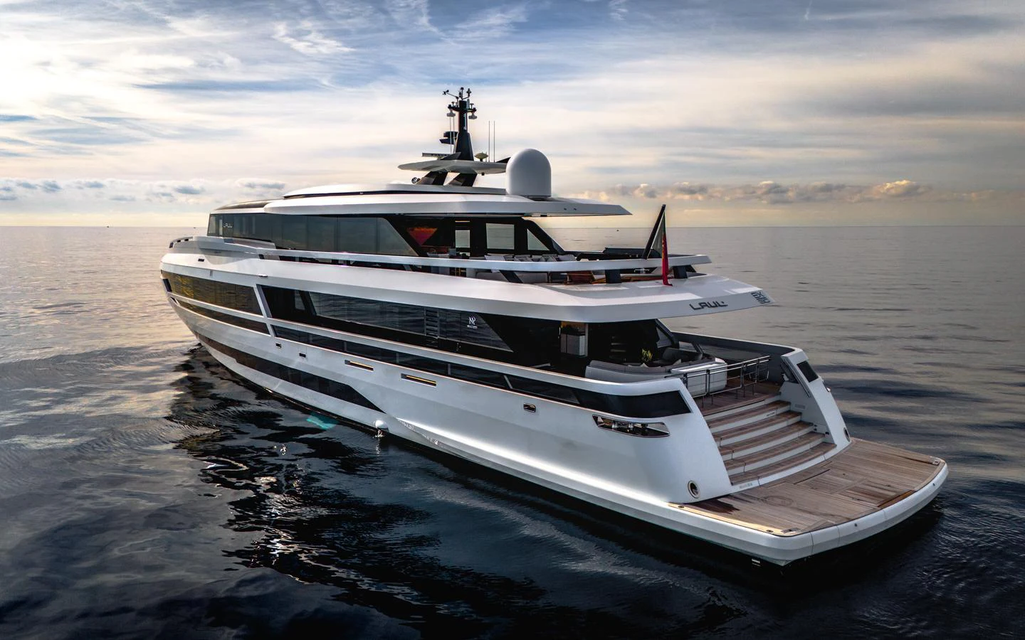 A sleek and modern yacht glides gracefully on calm waters under a serene sky. aboard L.A.U.L. Yacht for Sale
