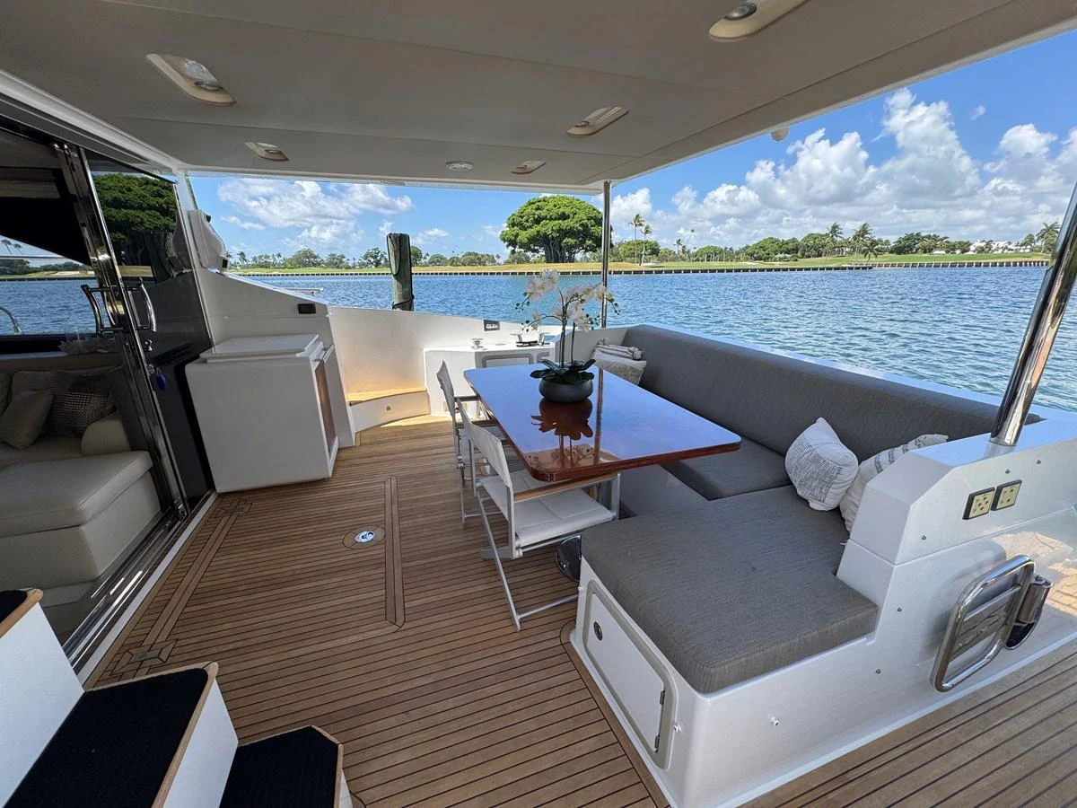 a room with a table chairs and a view of the ocean aboard XAX66046F718 Yacht for Sale