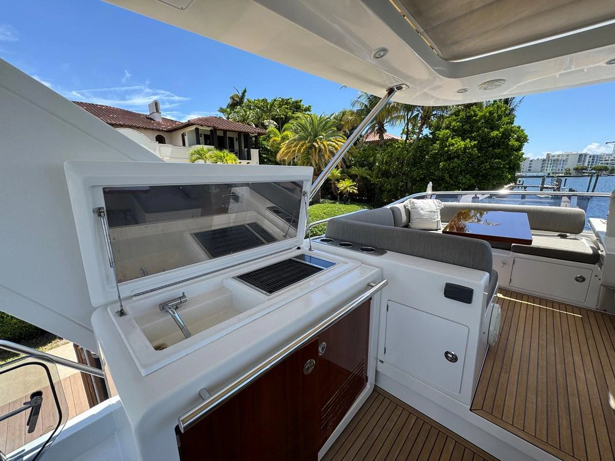 a deck with a barbecue and a pool aboard XAX66046F718 Yacht for Sale