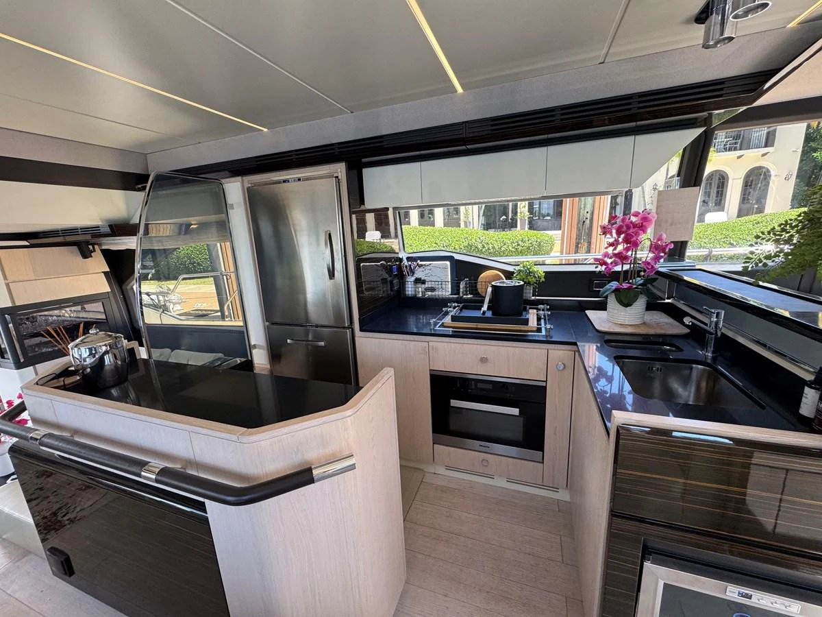 a kitchen with black cabinets aboard XAX66046F718 Yacht for Sale