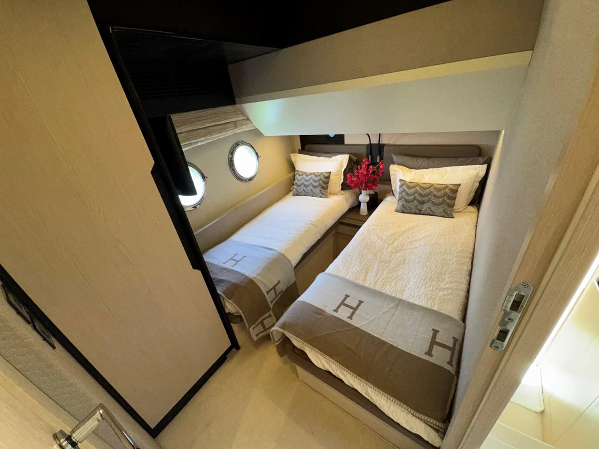 a room with a bed and a mirror aboard XAX66046F718 Yacht for Sale