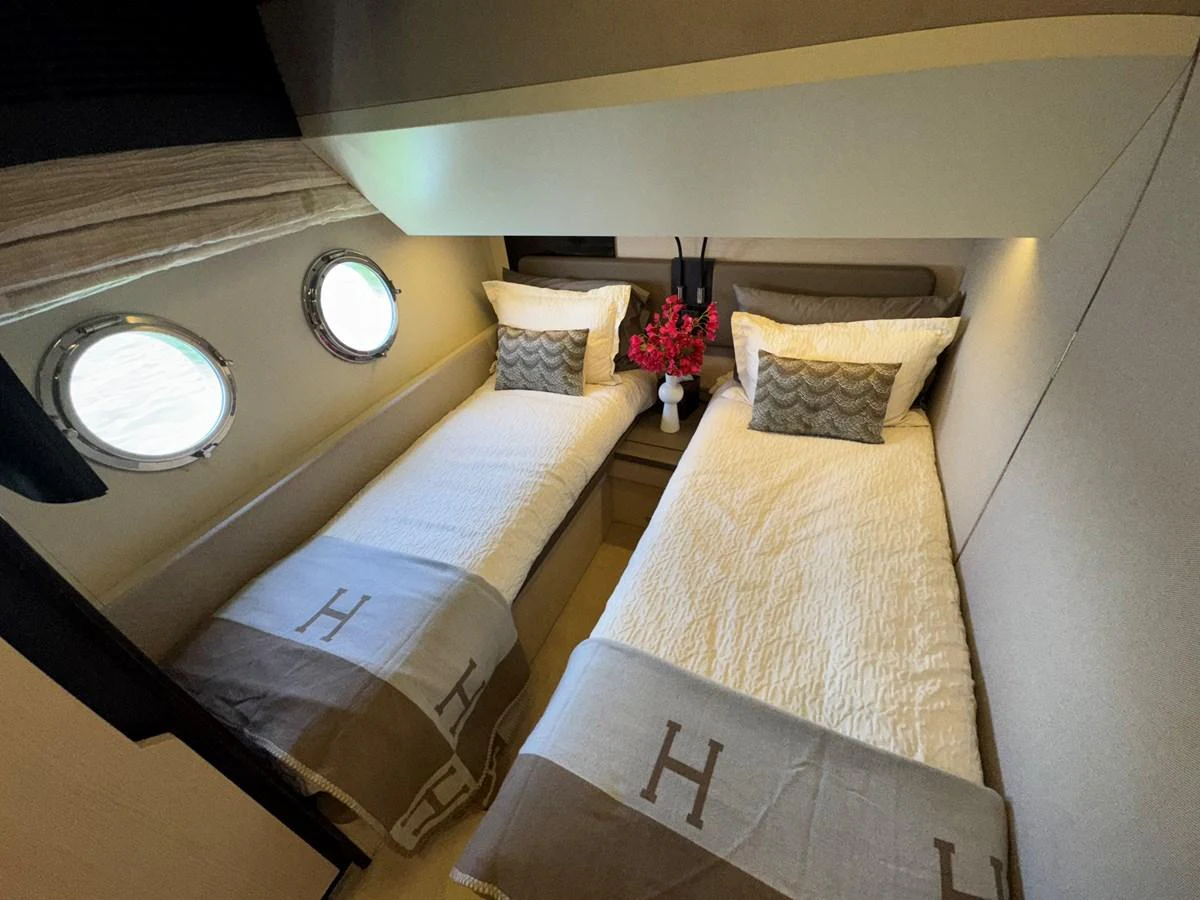 a room with a bed and a mirror aboard XAX66046F718 Yacht for Sale