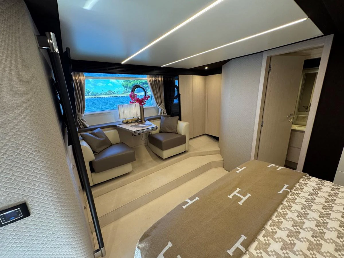 a room with a couch and a tv on the wall aboard XAX66046F718 Yacht for Sale