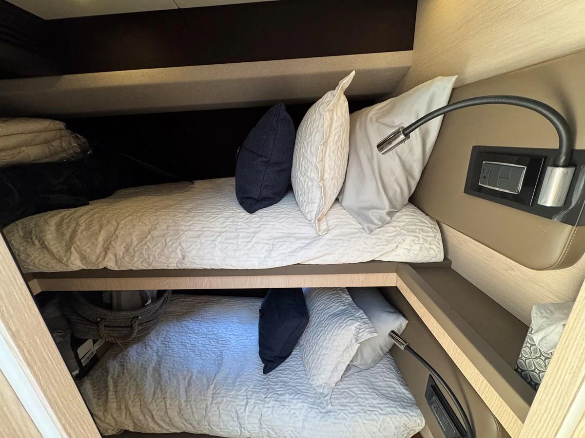 a bed with pillows and a towel aboard XAX66046F718 Yacht for Sale