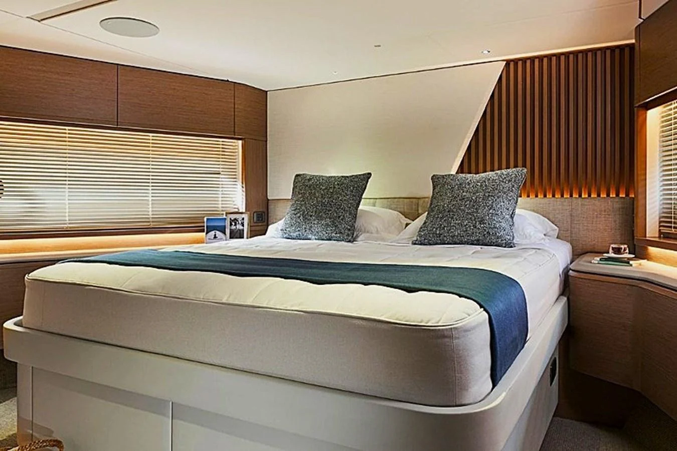 a bed with blue sheets aboard SOLOMON Yacht for Sale