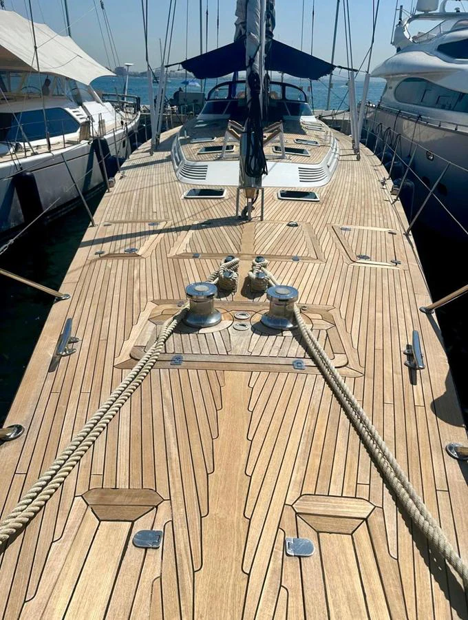The yacht's deck showcases elegant woodwork and sleek design, perfect for a luxurious sailing experience. aboard PERSISTENCE Yacht for Sale