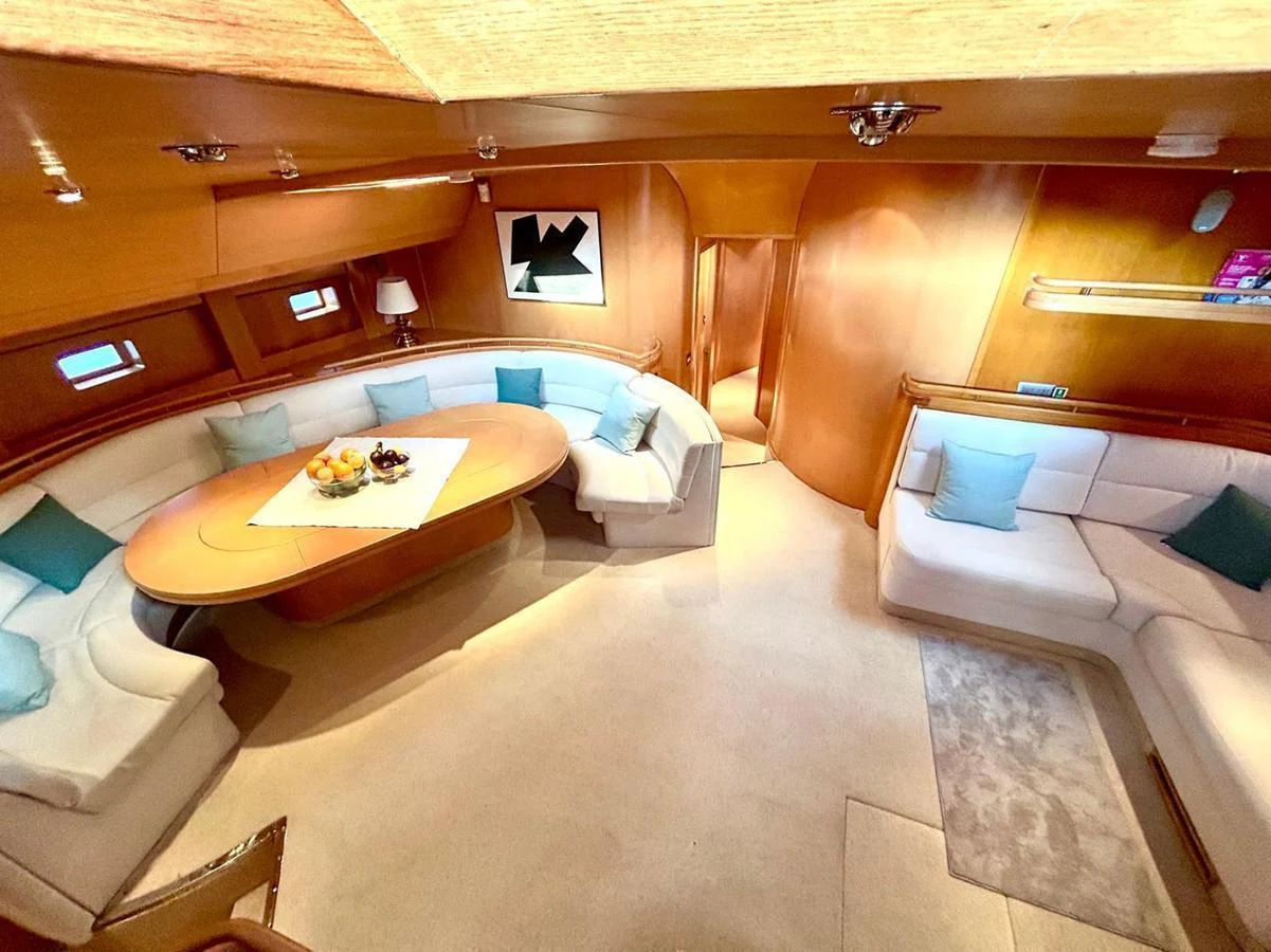 The yacht's salon features plush seating and a stylish dining area, creating a warm and inviting atmosphere. aboard PERSISTENCE Yacht for Sale