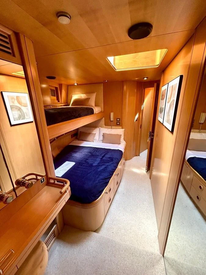 A cozy cabin with bunk beds and warm wooden finishes. aboard PERSISTENCE Yacht for Sale