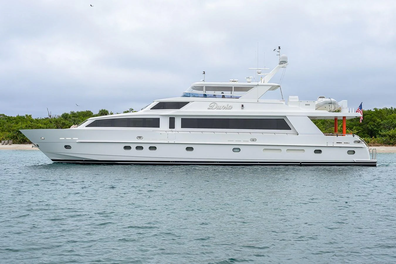 a white yacht in the water aboard DUNIA Yacht for Sale
