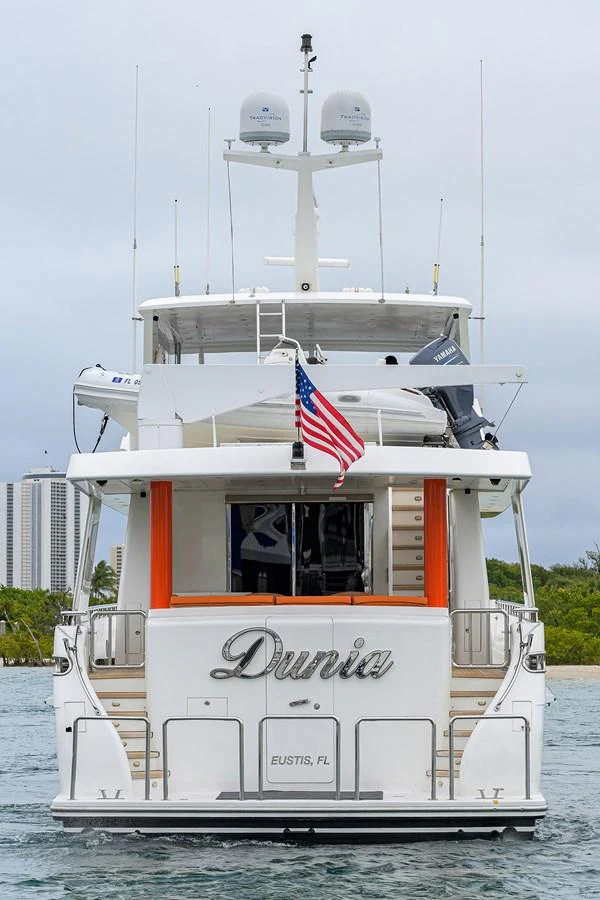 a boat with a flag on the front aboard DUNIA Yacht for Sale