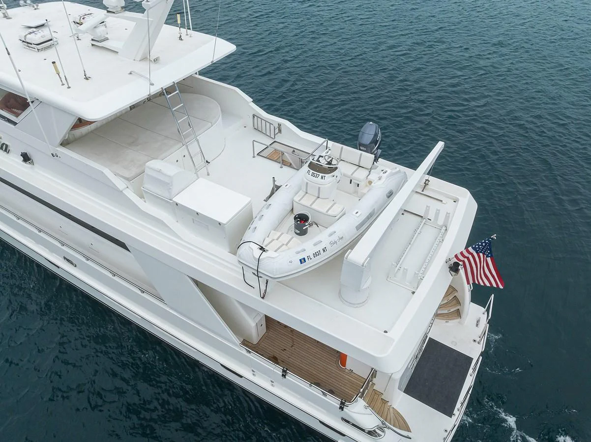 a large white ship with a flag on it aboard DUNIA Yacht for Sale