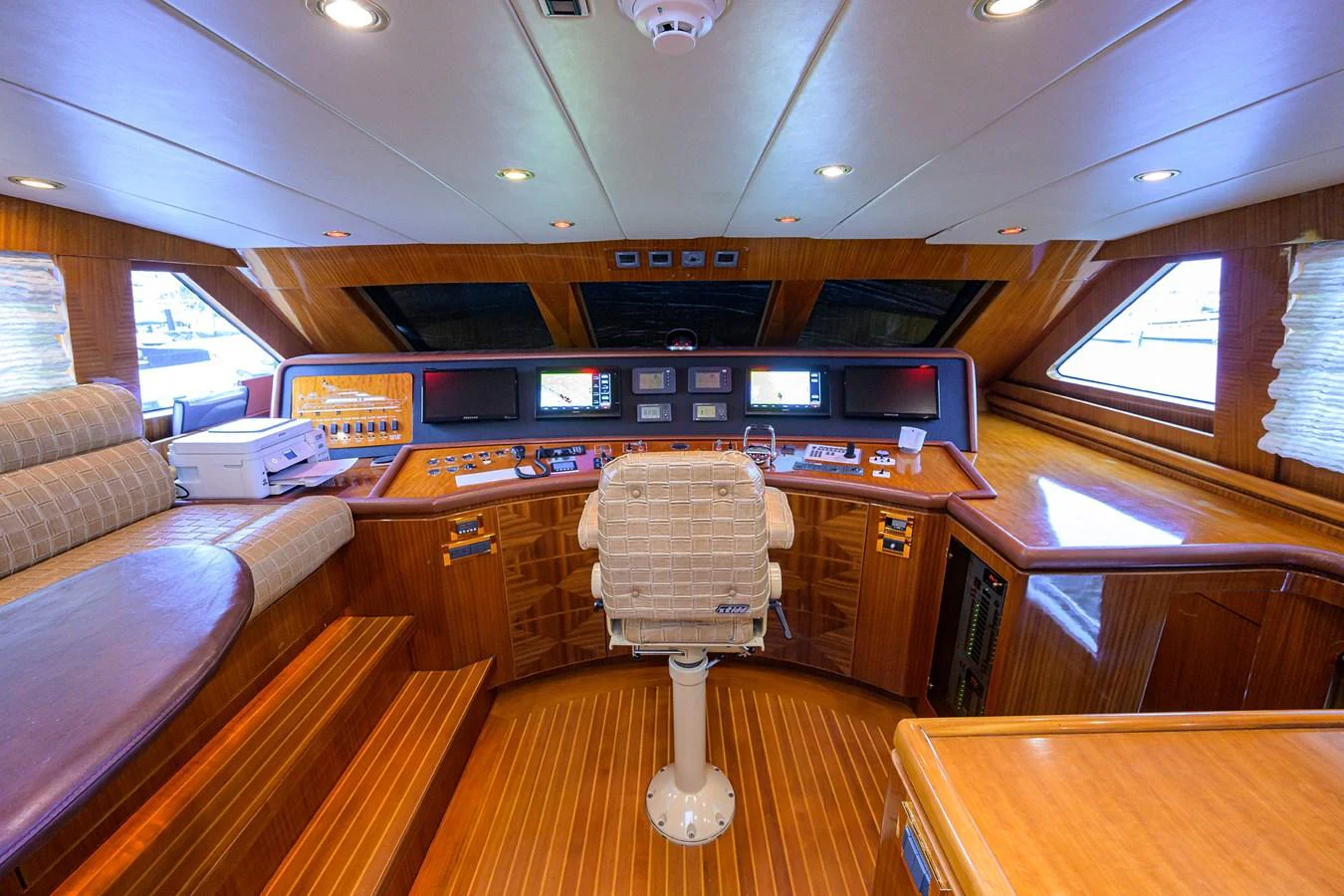 a room with a table and a couch aboard DUNIA Yacht for Sale