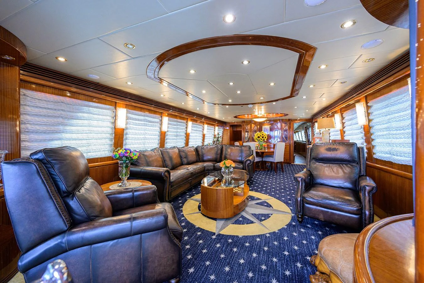 a living room with leather couches aboard DUNIA Yacht for Sale