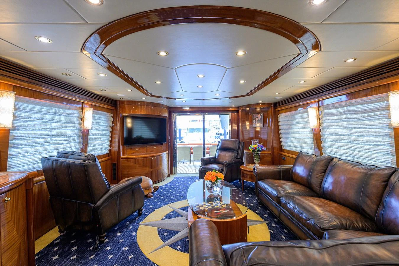 a living room with leather furniture aboard DUNIA Yacht for Sale
