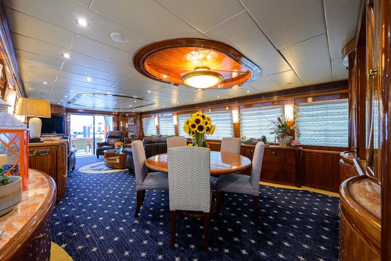 a dining room with a table and chairs aboard DUNIA Yacht for Sale