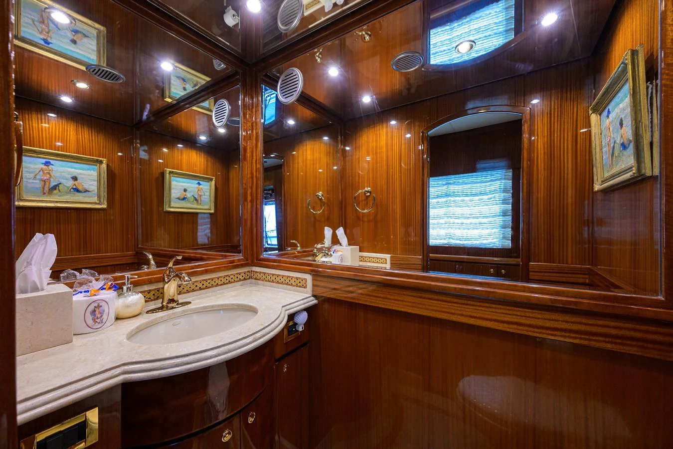 a bathroom with wooden cabinets aboard DUNIA Yacht for Sale
