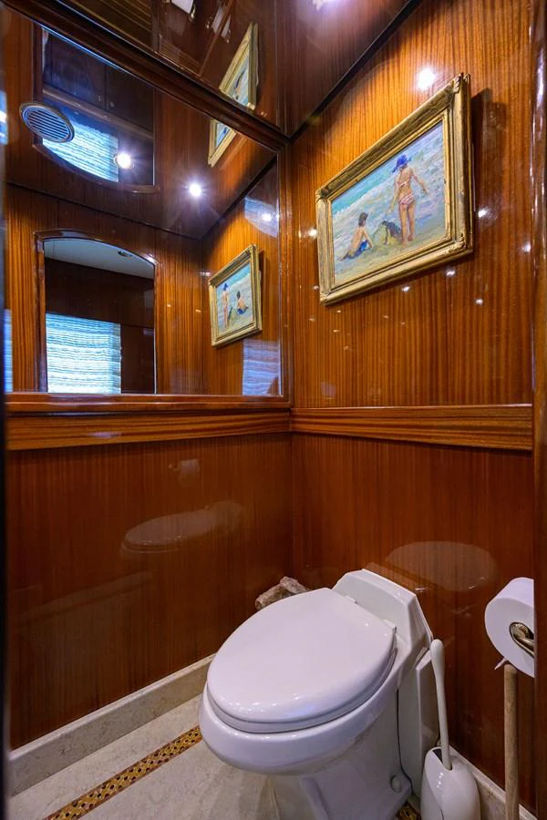 a bathroom with a toilet and a mirror aboard DUNIA Yacht for Sale