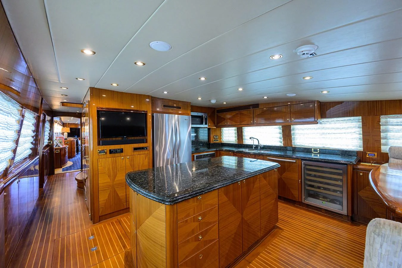 a large kitchen with a bar and bar aboard DUNIA Yacht for Sale