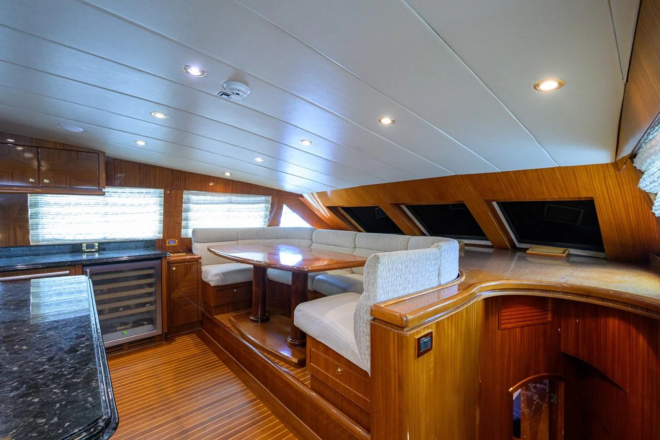 a room with a table and chairs aboard DUNIA Yacht for Sale