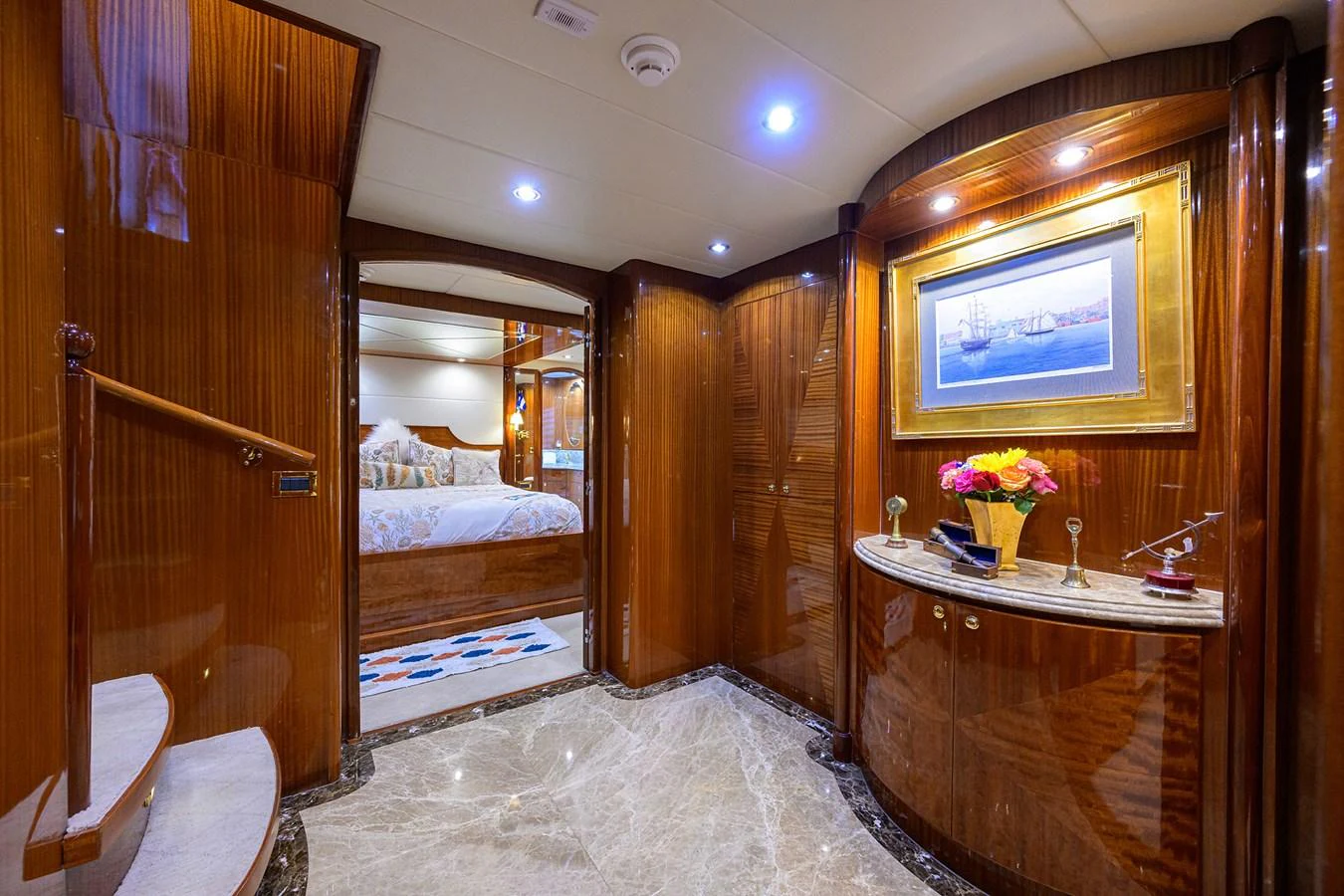 a room with a bed and a mirror aboard DUNIA Yacht for Sale