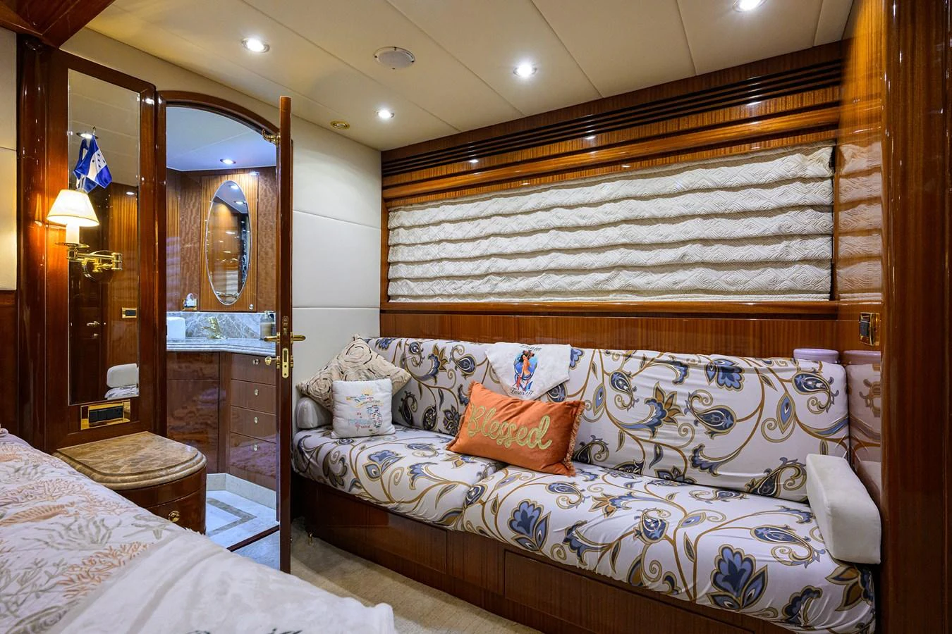 a bed with a mirror above it aboard DUNIA Yacht for Sale