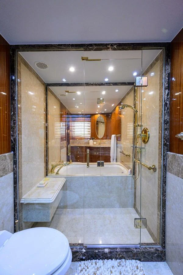 a bathroom with a tub sink and toilet aboard DUNIA Yacht for Sale